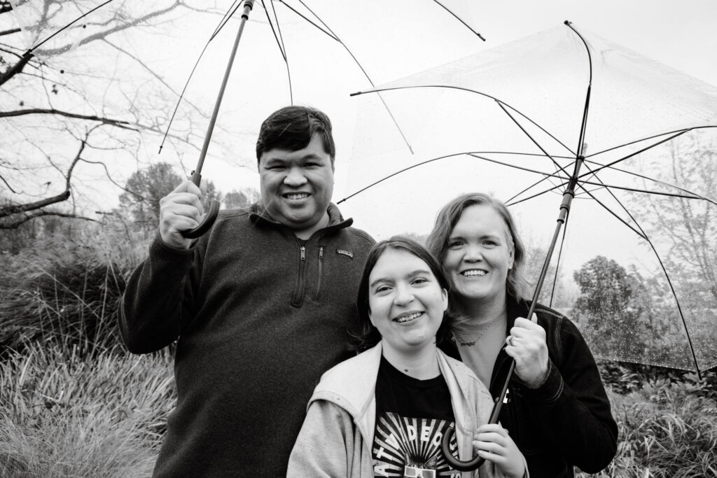 Carrie with her family under clear umbrellas in the Seattle rain